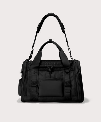 Person carrying Vano pet carrier with small dog inside