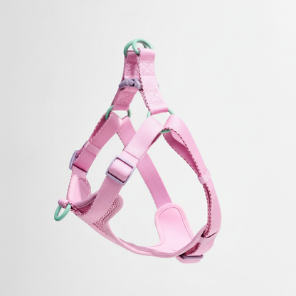 Pink dog harness on a light gray background