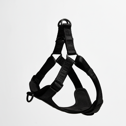 Black dog harness on a light gray background
