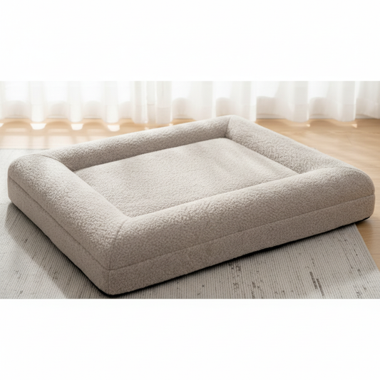 Beige pet bed on a wooden floor with a blurred background