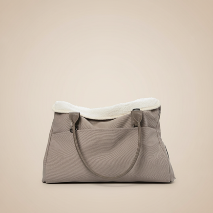 Premium dog tote carrier bag in beige with small dog inside, showing front view with multiple pockets and comfortable handles