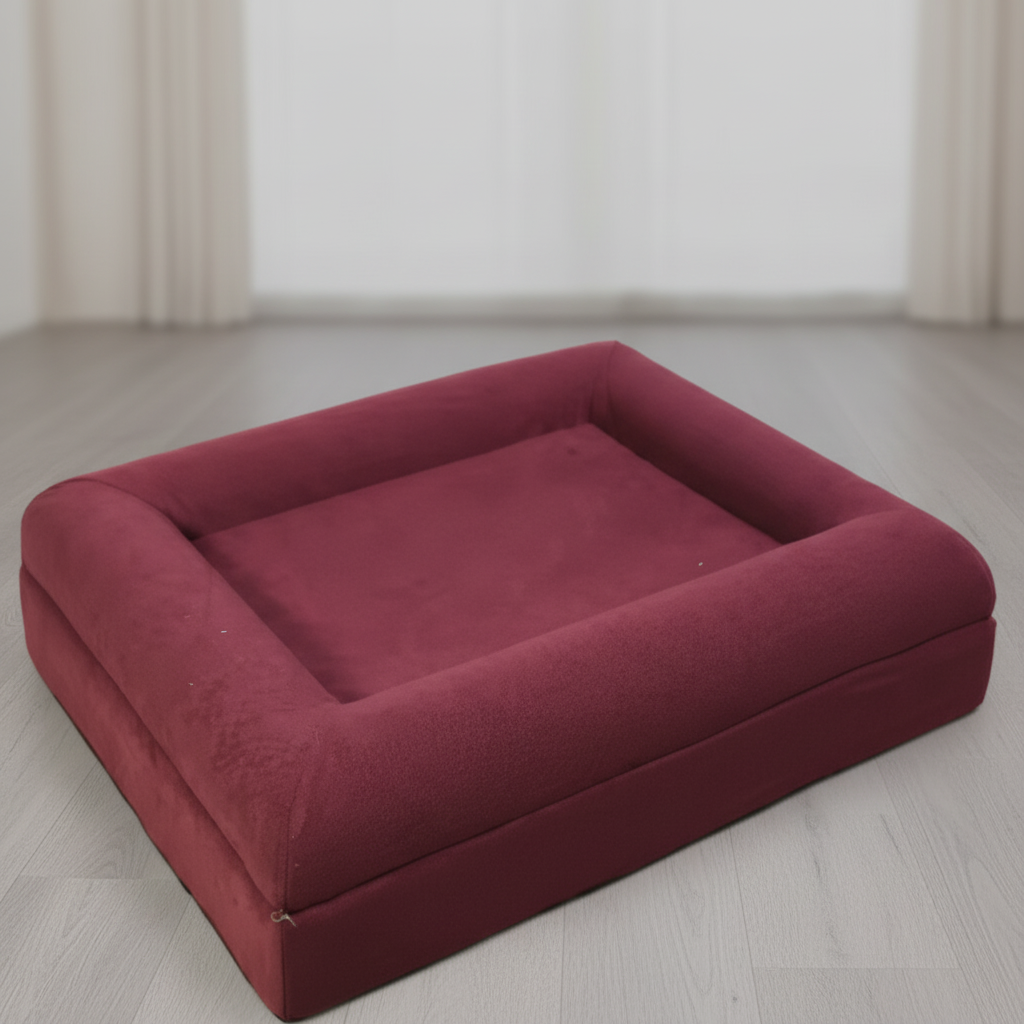 Red pet bed on gray floor 